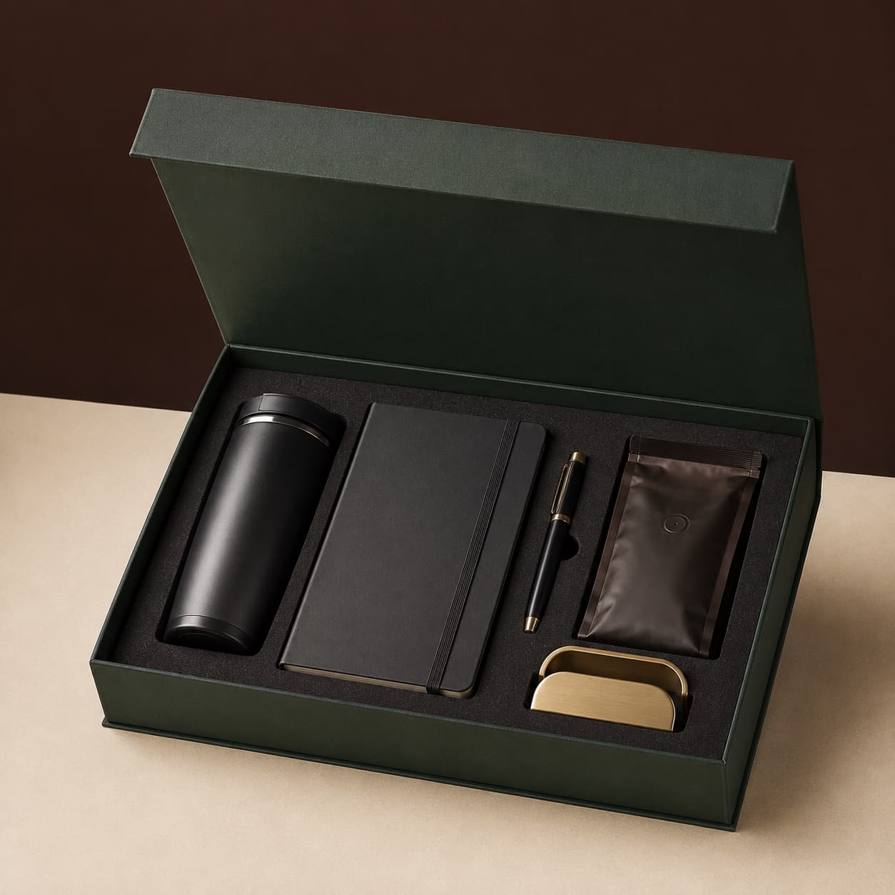 A forest-green corporate gift box with useful premium desk pieces