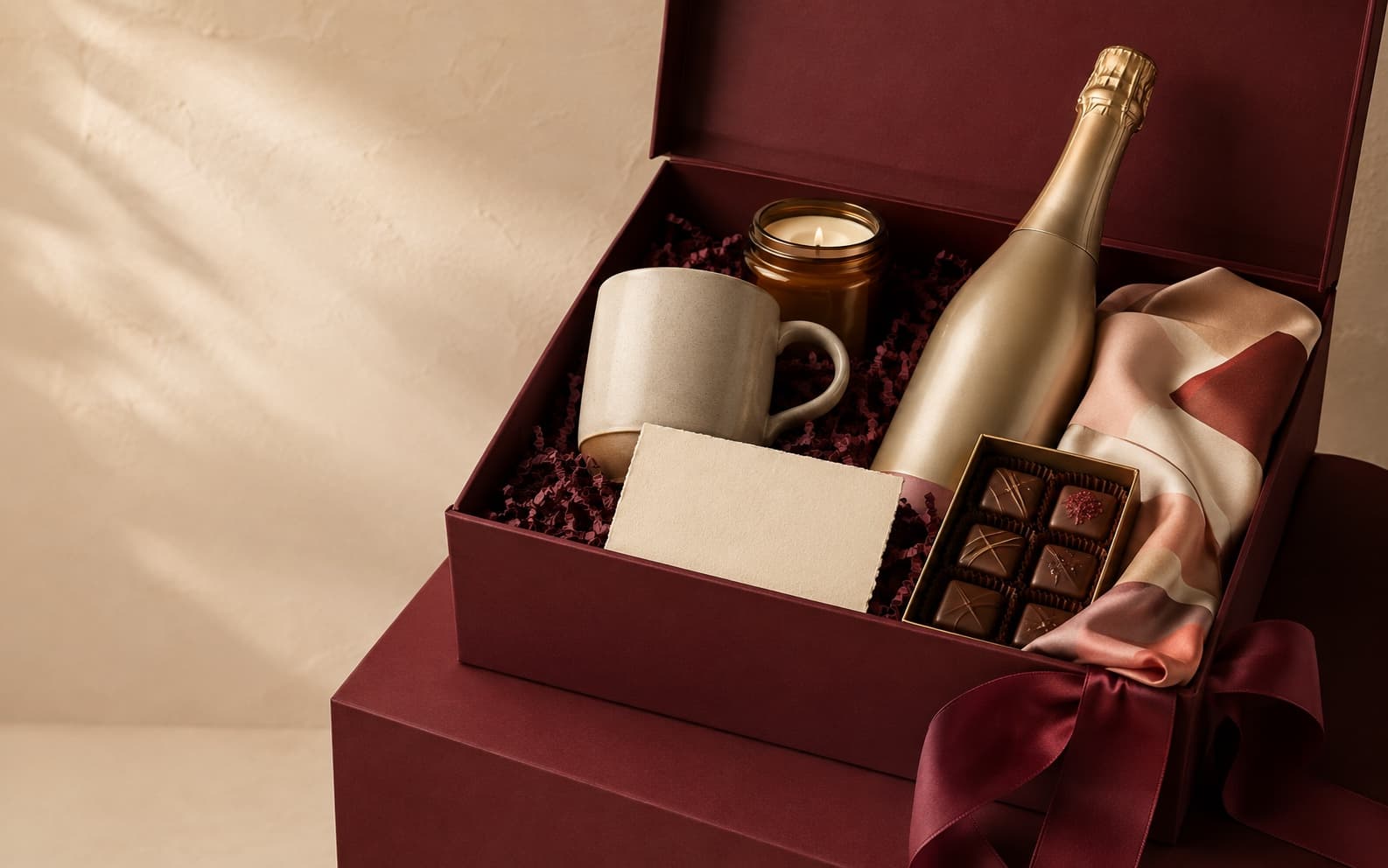 A burgundy GiftGranter hamper filled with considered treats and keepsakes